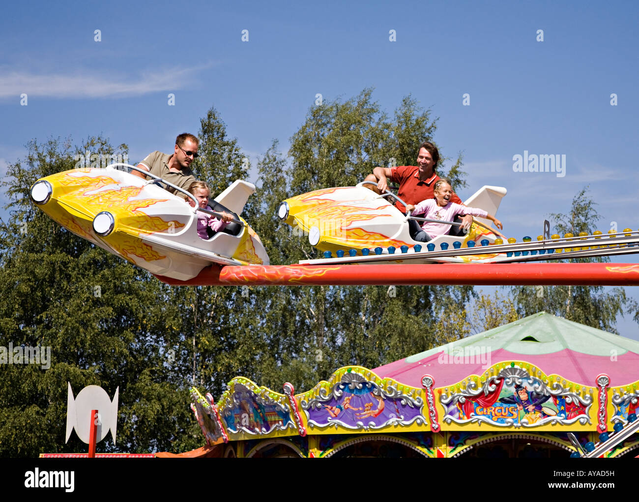 Adults and children on funfair aeroplane ride Frauenau Bavaria Germany Stock Photo