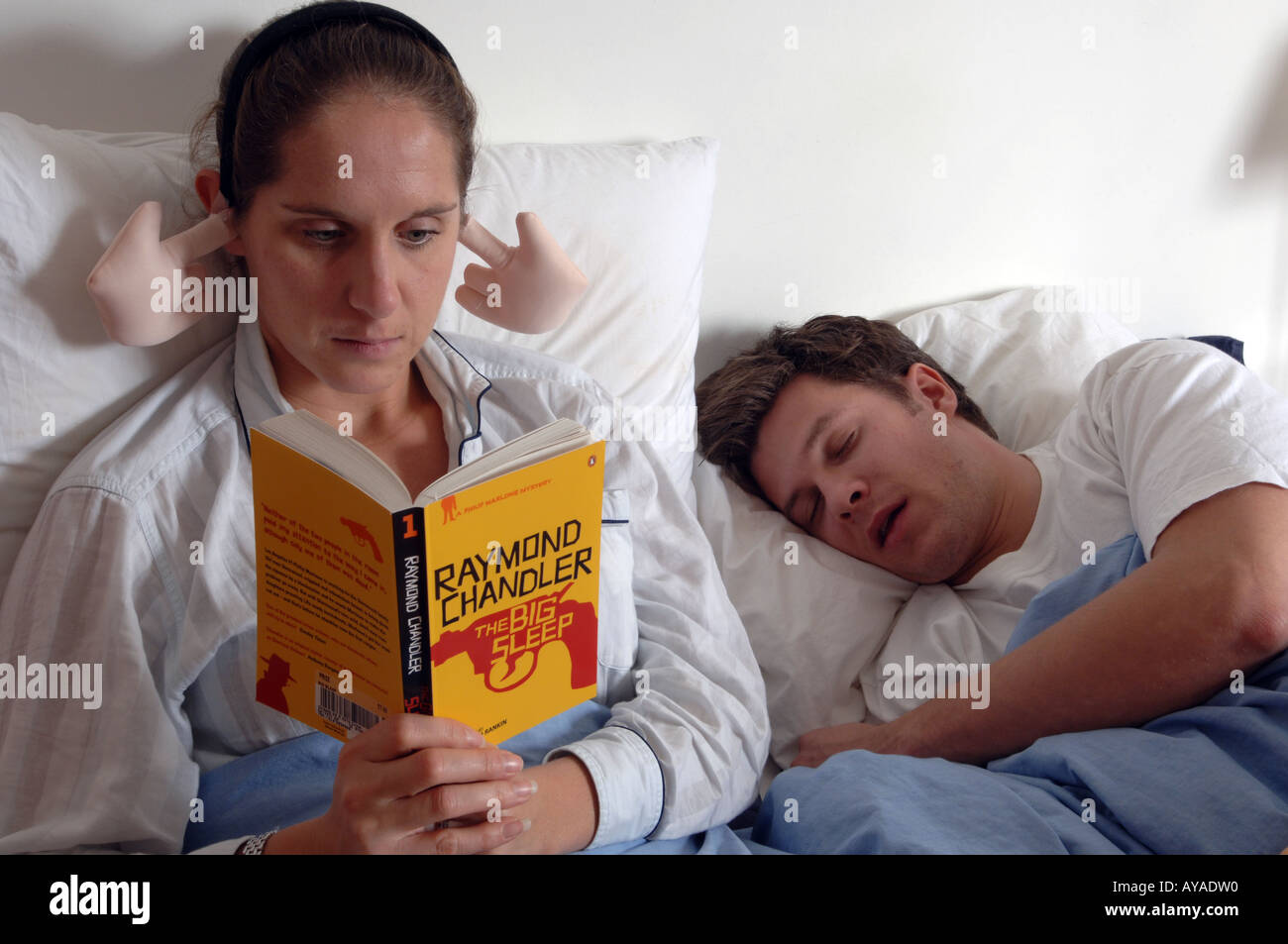 Angry young woman wears joke shop earmuffs to block out sound of