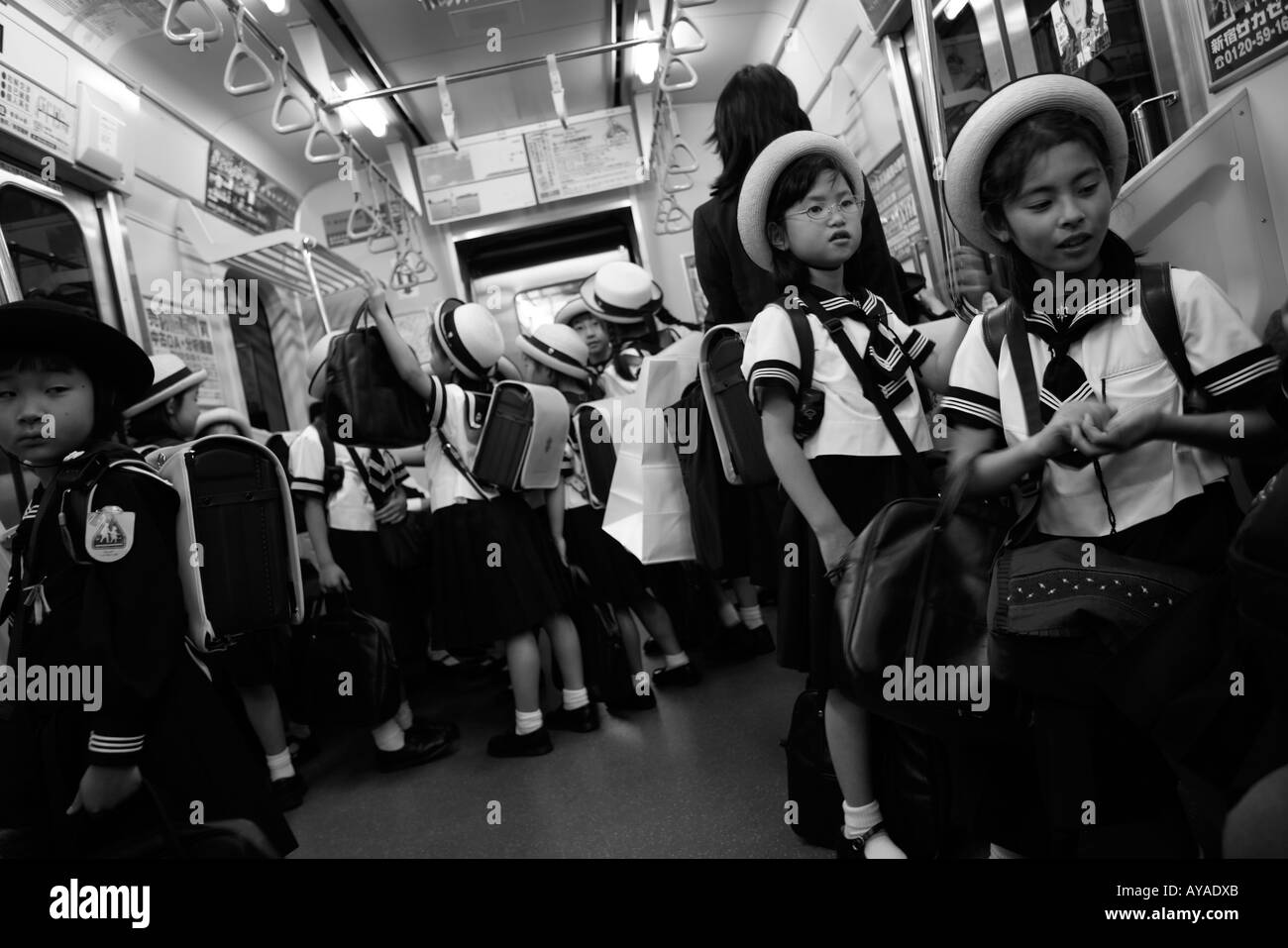 Asia Tokyo Japan Young school girl in uniform on subway train Stock Photo