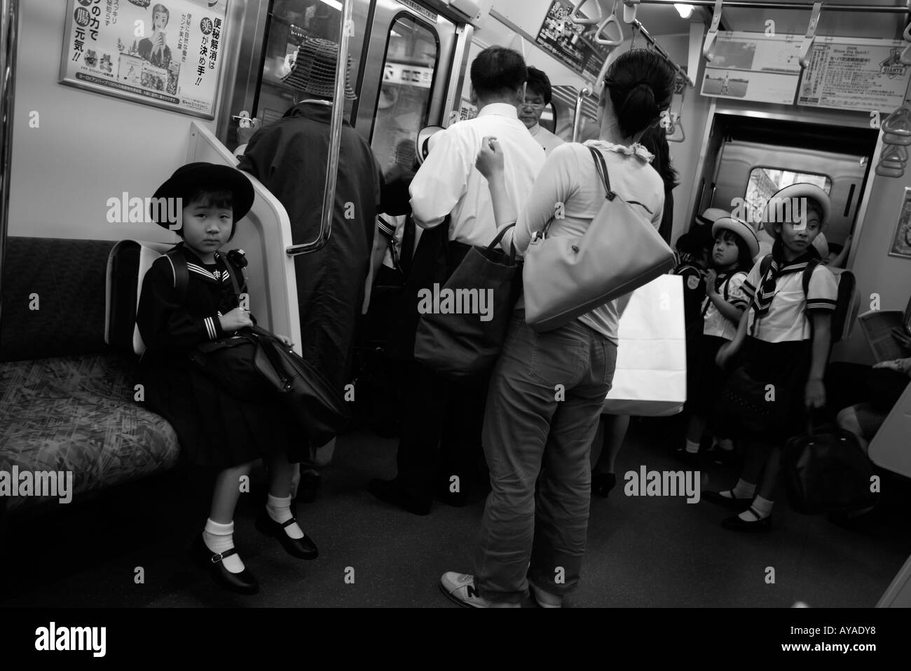 Asia Tokyo Japan Young school girl in uniform on subway train Stock Photo