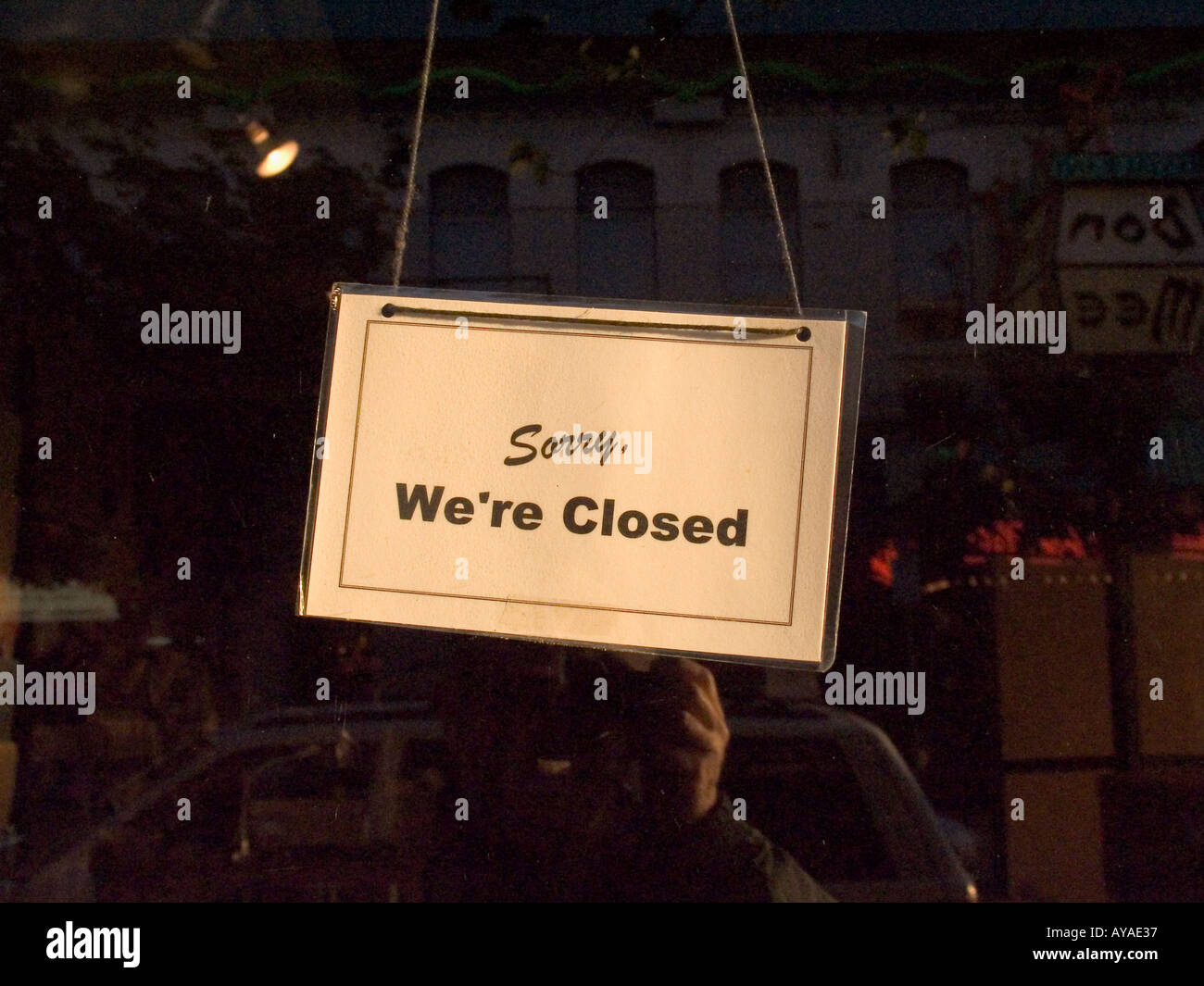 Sorry we are closed sign hanging in shop window Stock Photo