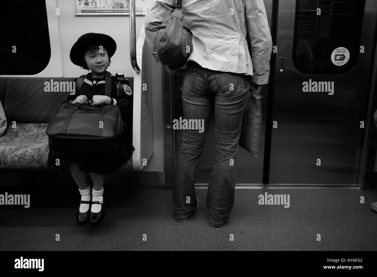 Asia Tokyo Japan Young school girl in uniform on subway train Stock Photo