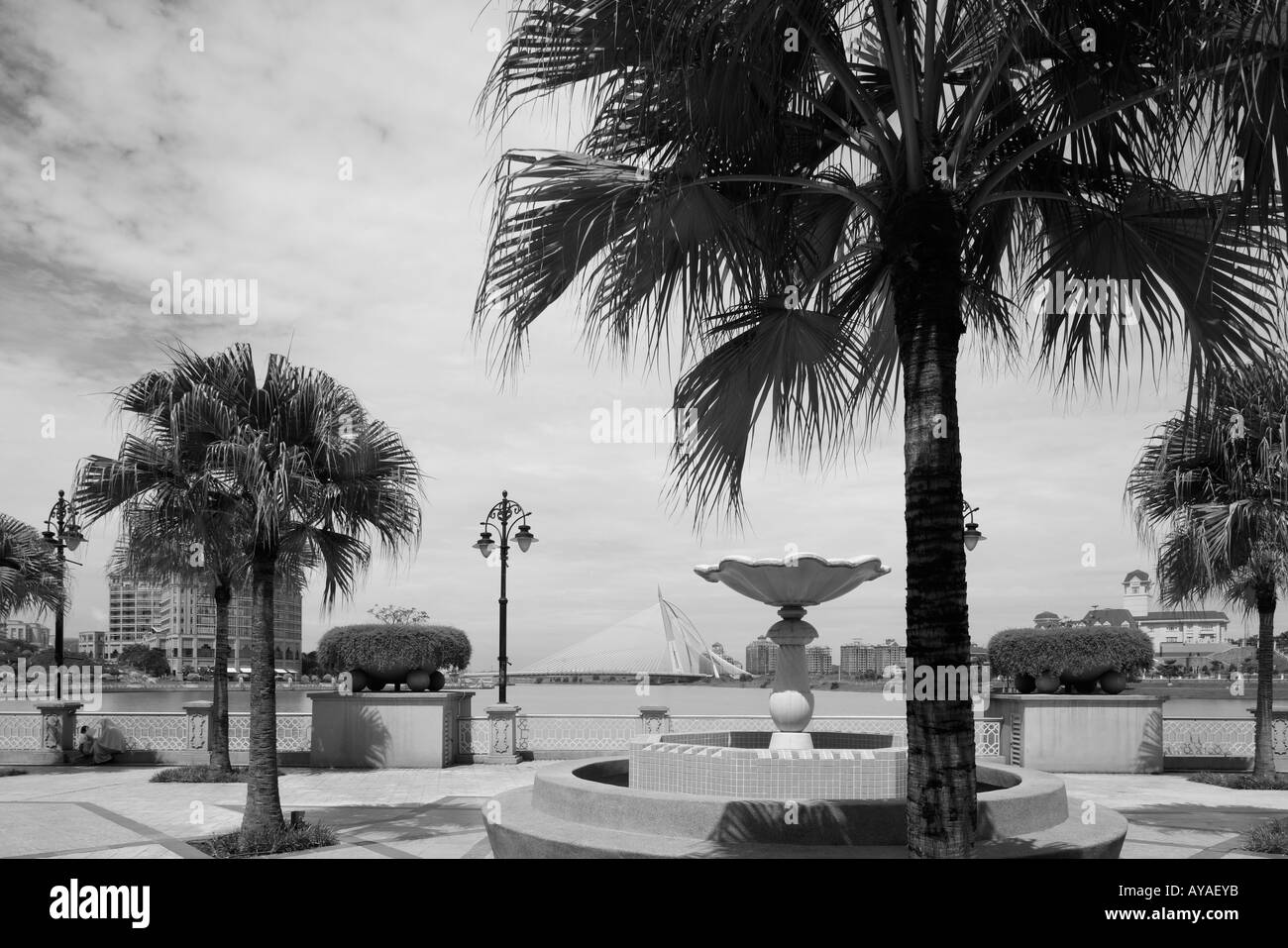Malaysia Kuala Lumpur Palm trees and gardens along artificial lake