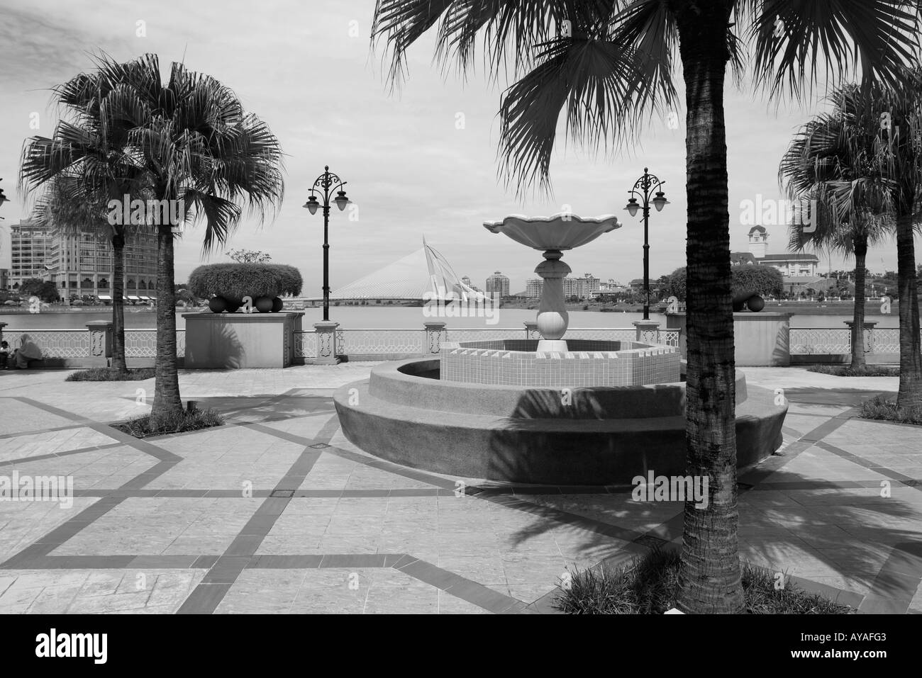 Malaysia Kuala Lumpur Palm trees and gardens along artificial lake ...