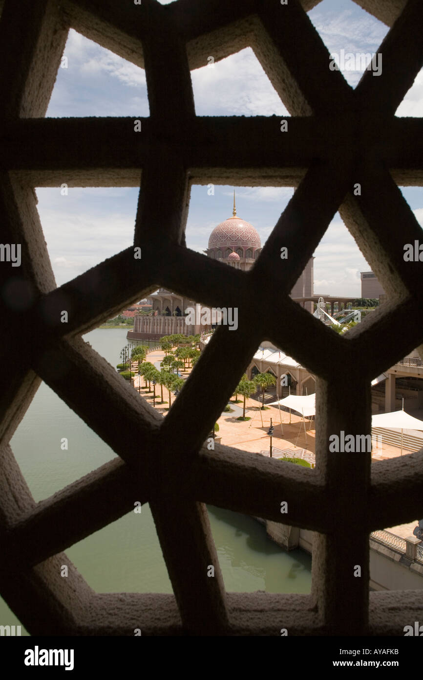 Malaysia Kuala Lumpur View throough brickwork of dome and minaret of Putra Mosque in center of new administrative capital city Stock Photo