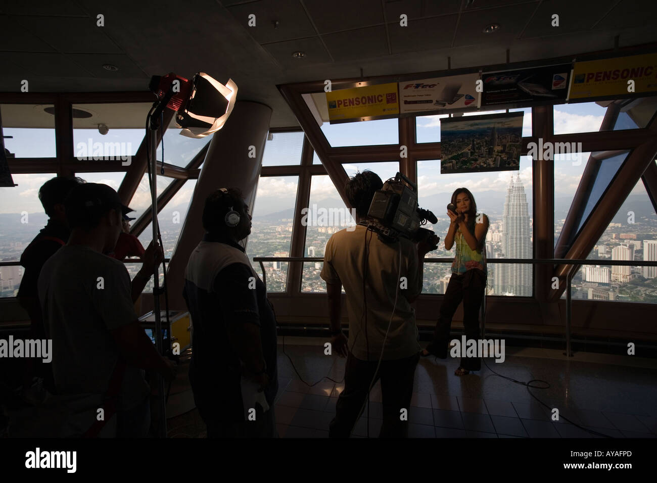 Malaysia Kuala Lumpur Film crew shooting television news feature from