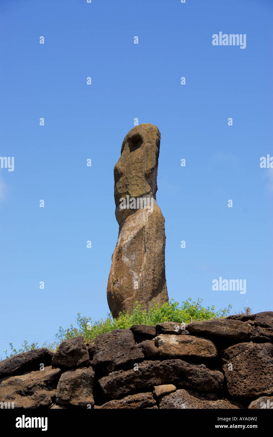 Chile Easter Island Ahu Riata moai Statue on Platform faces left of clear day blue sky background Stock Photo