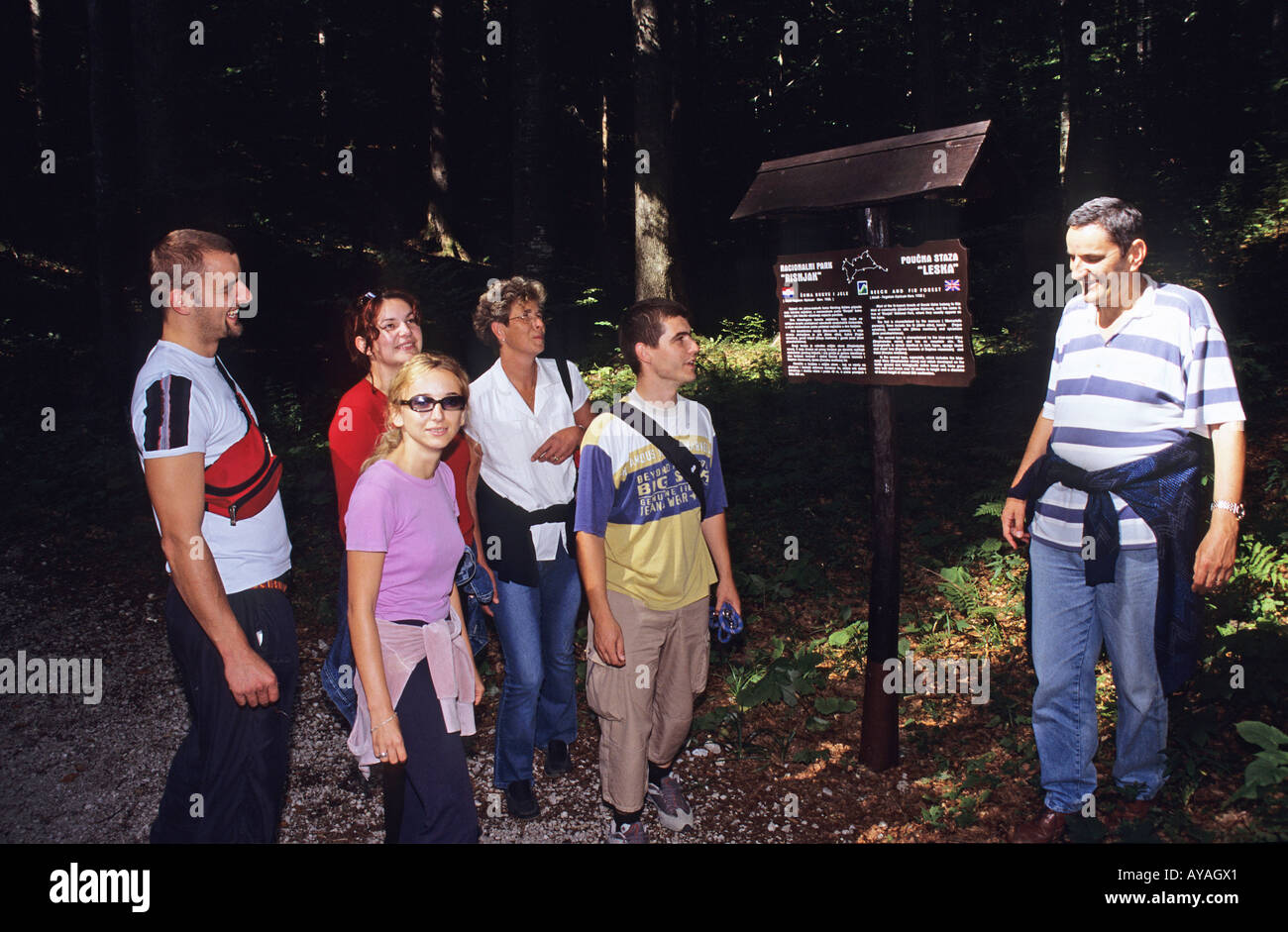 Walkers reading Leska Train information panel in the Risnjak National