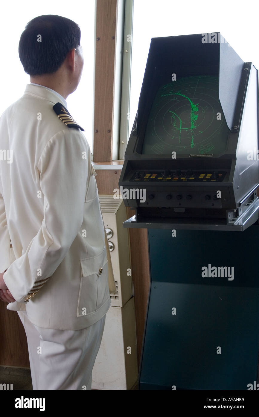 Chinese cruise ship captain watching the radar screen as they navigate the Yangtze River in