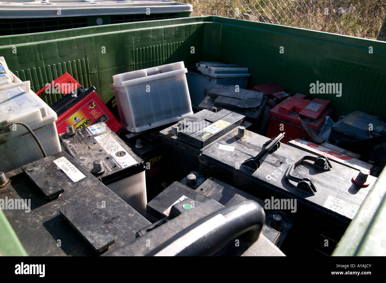 Waste lead acid batteries in a green box at a household recycling