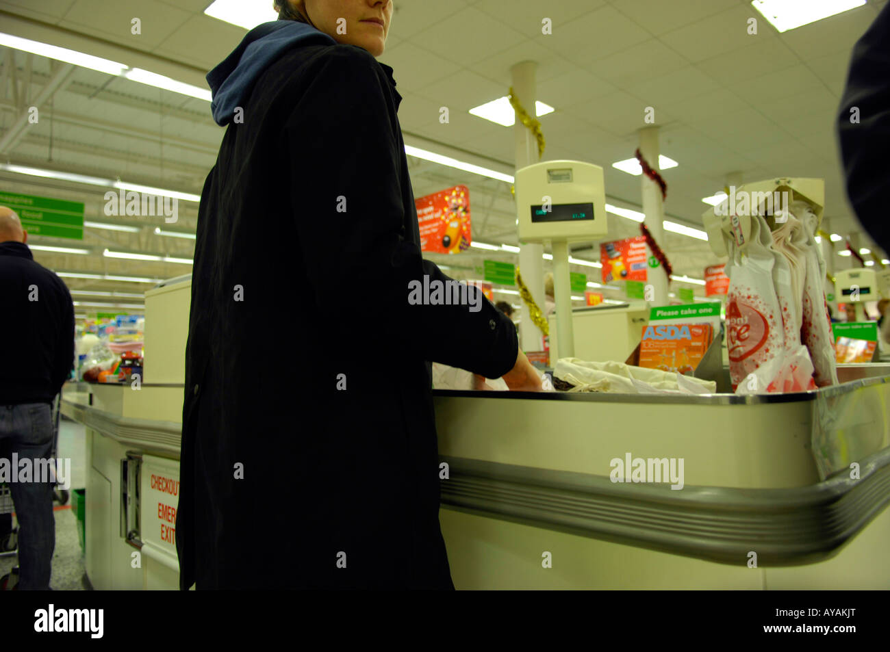 woman female check out asda supermarket shopping consumerism modern Stock Photo