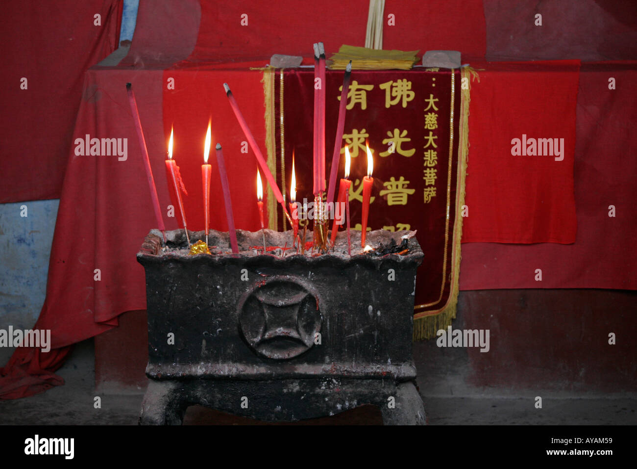 Buddhist shrine and burning candles in the Ghost City of Fengdu in
