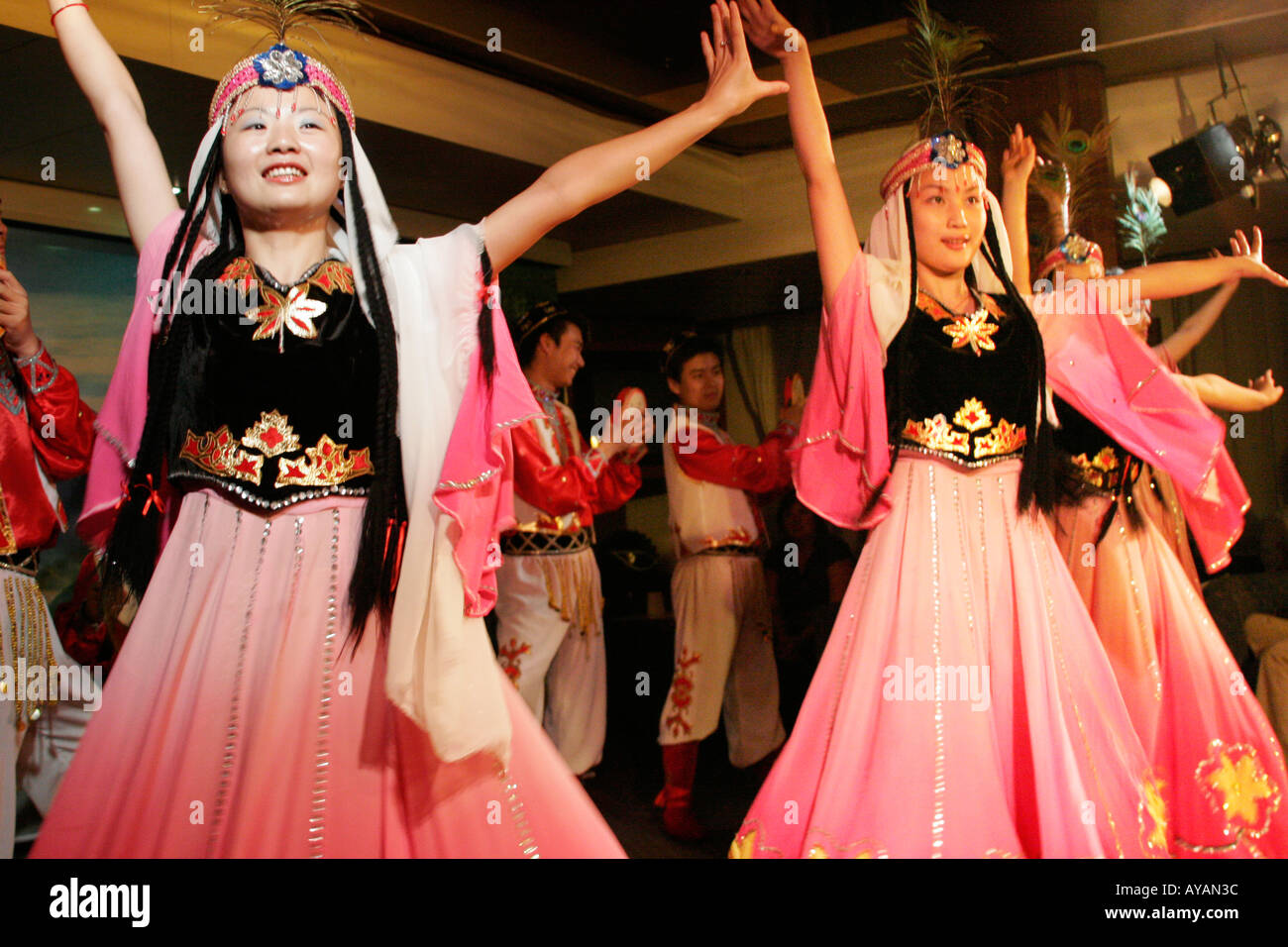 Chinese girls in traditional dresses dancing on a Yangtze River boat cruise ship in China Stock Photo