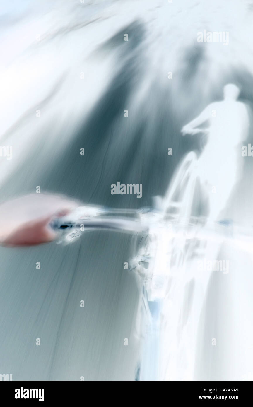 inverted long exposure of cyclist's shadow as bike races down street ...