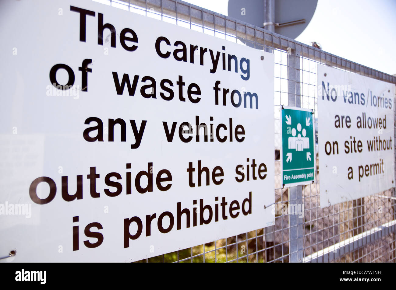 carrying of waste from any vehicle outside  of the site is prohibited white metal sign on a fence Stock Photo