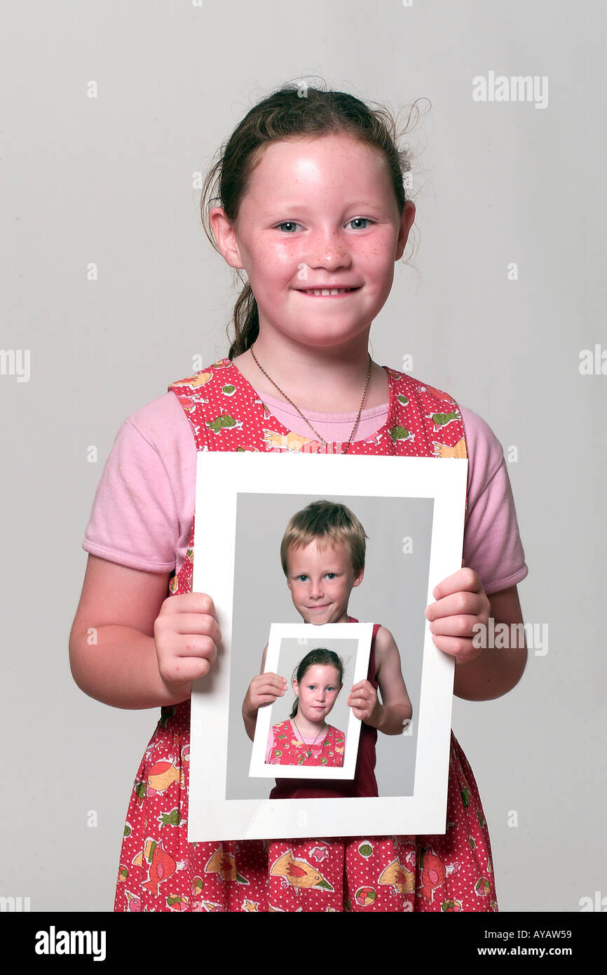 Girl holding picture of boy holding picture of boy, portrait Stock ...