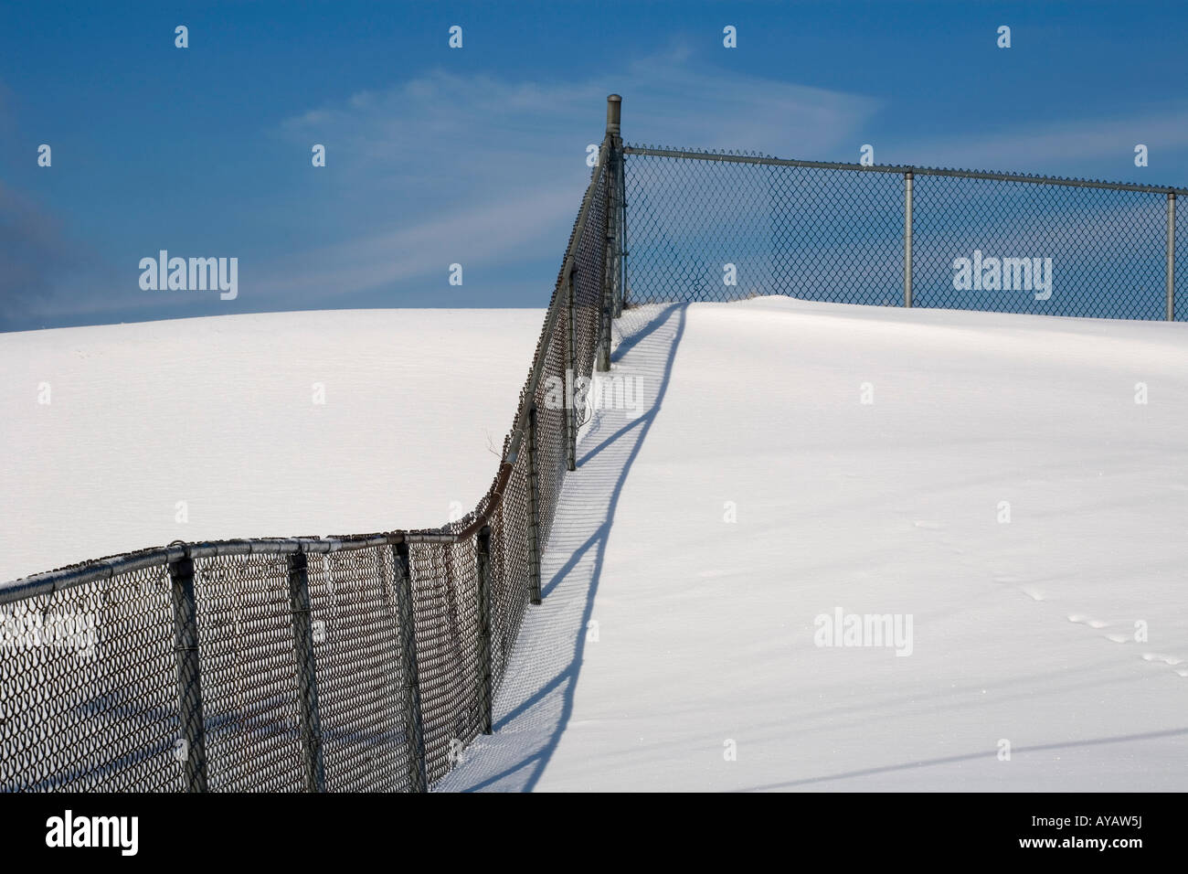 Chain link fence in the snow Stock Photo - Alamy