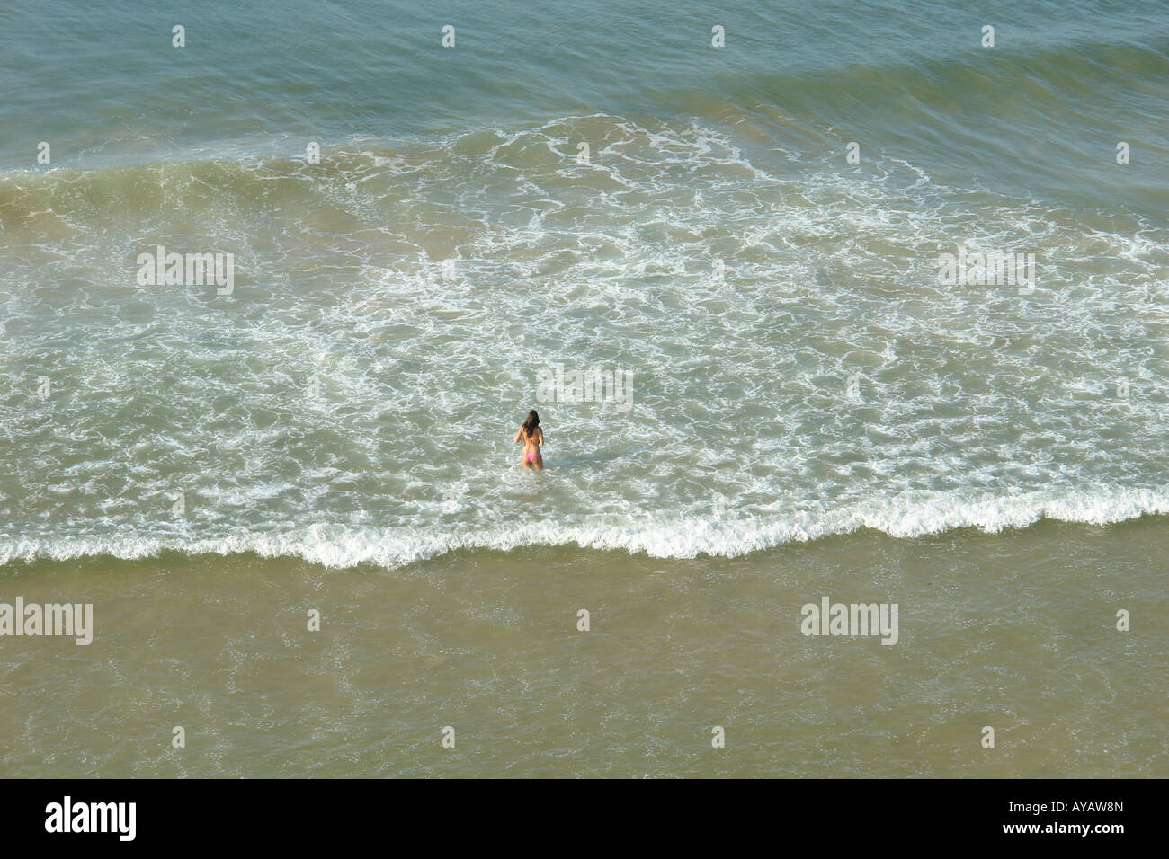 Woman Wading in Ocean, Algarve, Portugal Stock Photo