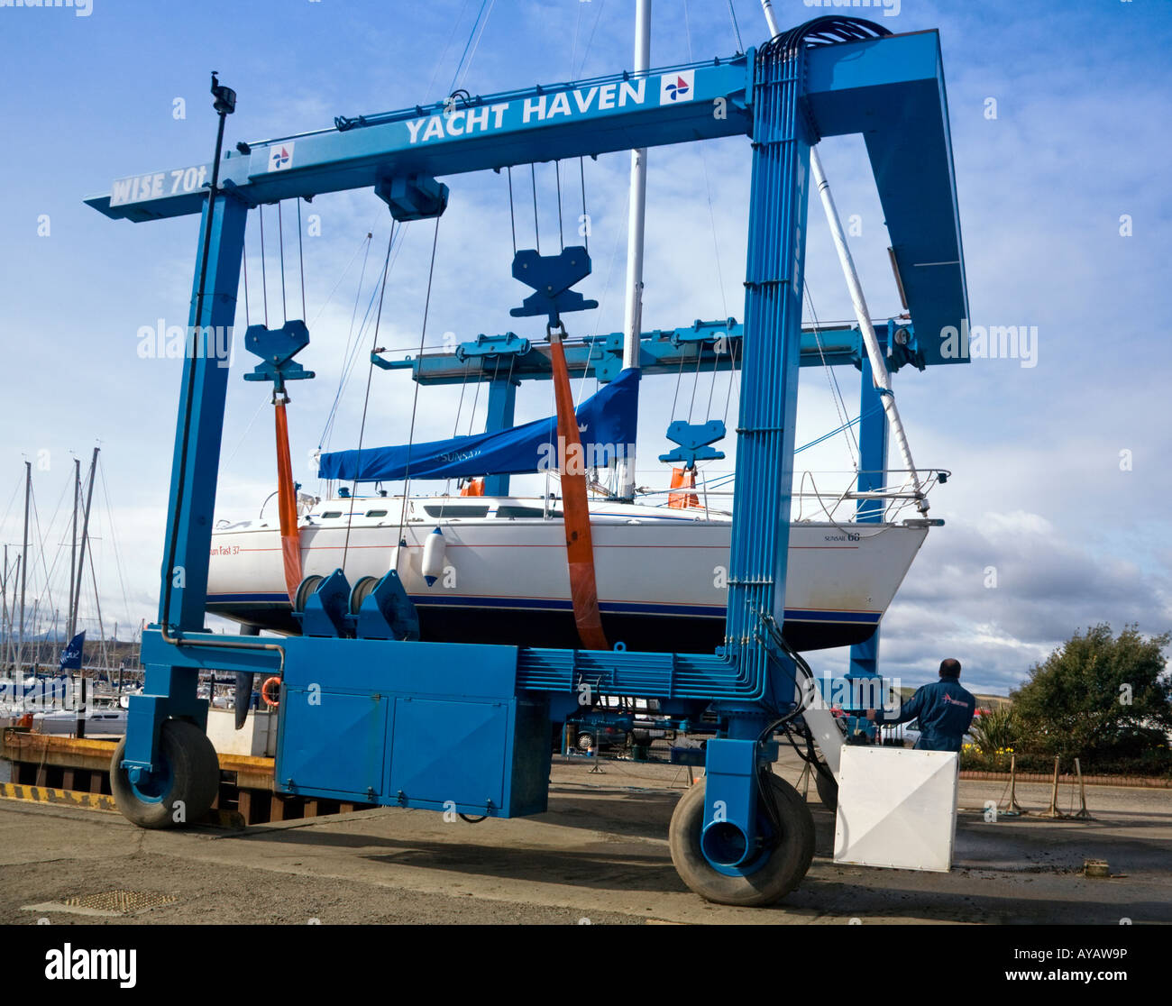 A yacht suspended in a Wise 70 ton boat hoist at largs marina, Ayrshire, Scotland Stock Photo