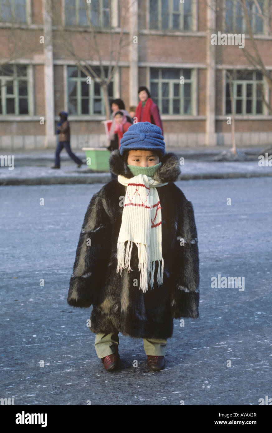 Child in outsized fur coat, Taoshan, north-east China in sub-zero temperatures Stock Photo