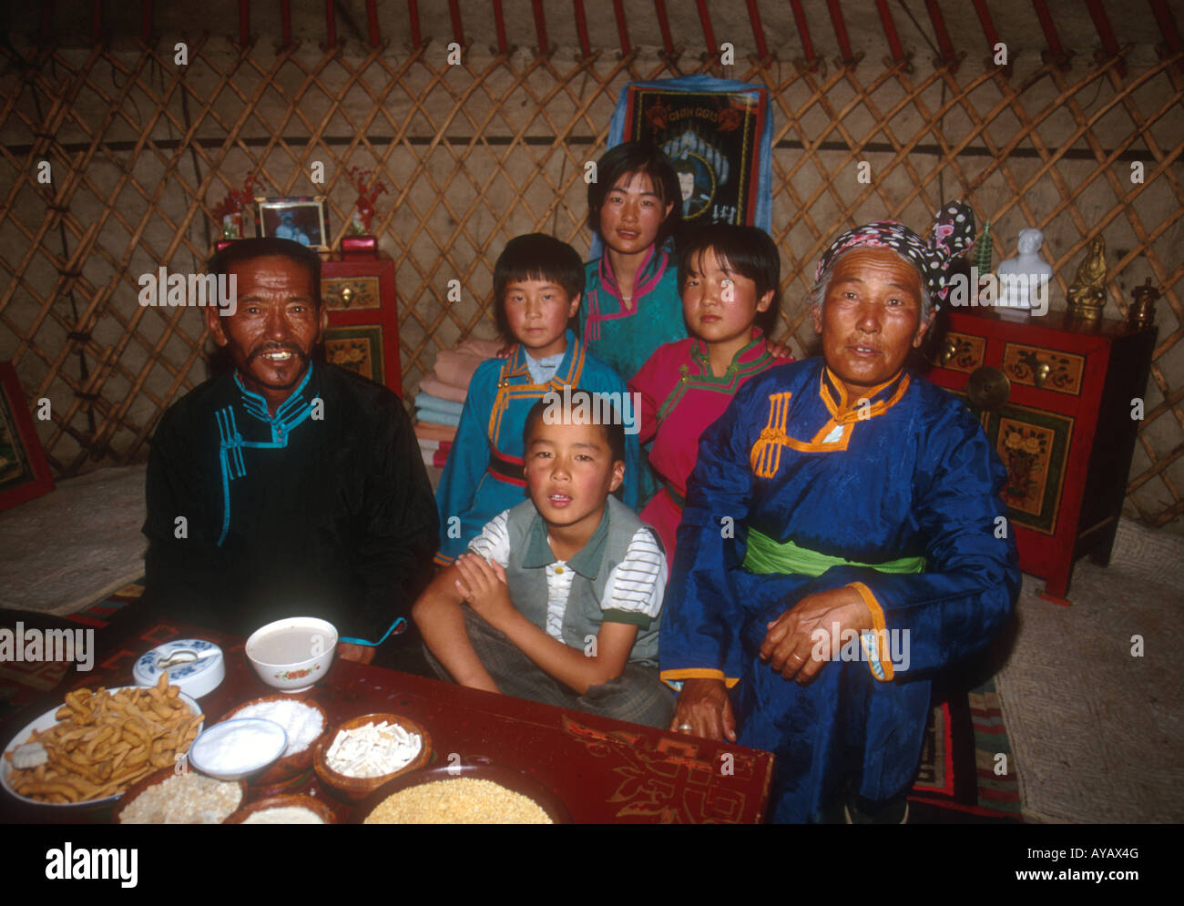 Mongolian family inside yurt on grasslands of Siziwang Banner near Hohhot in Inner Mongolia Stock Photo