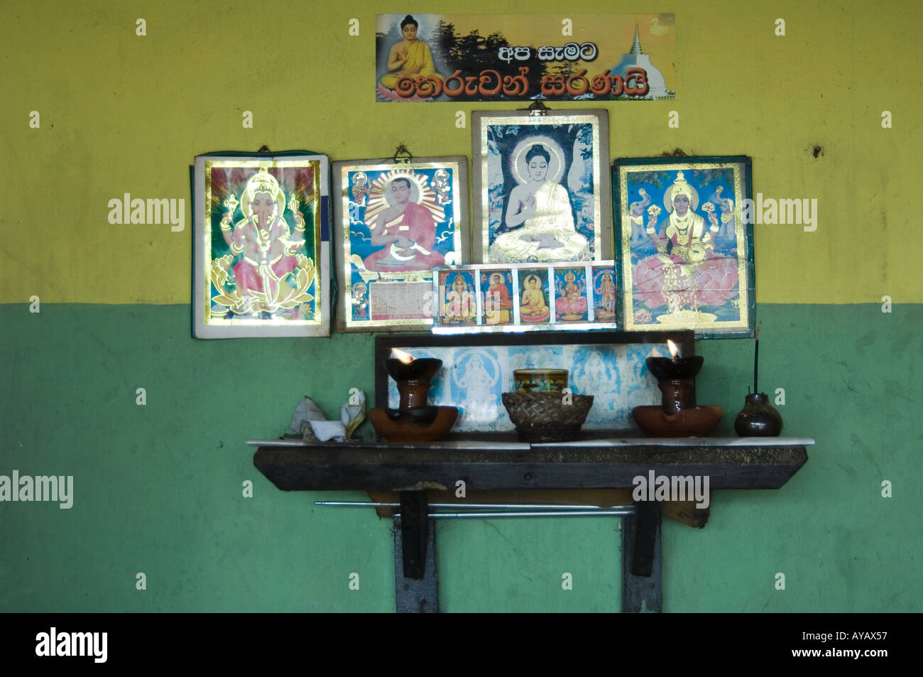 Small shrine to Hindu gods [and Buddha?] in a home near Pinnawala, Sri Lanka. Stock Photo