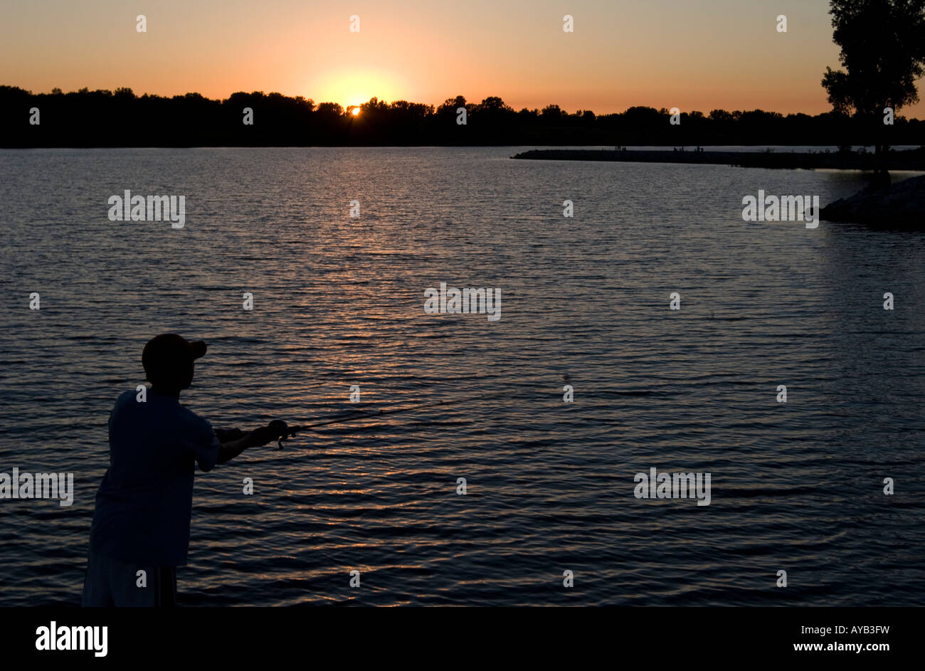 A boy fishes at Holmes Lake in Lincoln, Nebraska, June 11, 2005 Stock