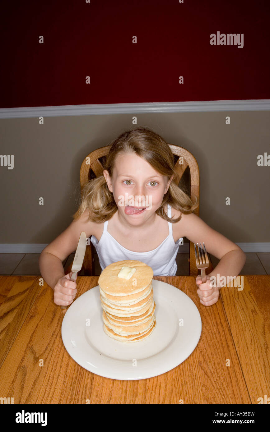 Child ready to eat huge stack of pancakes Stock Photo