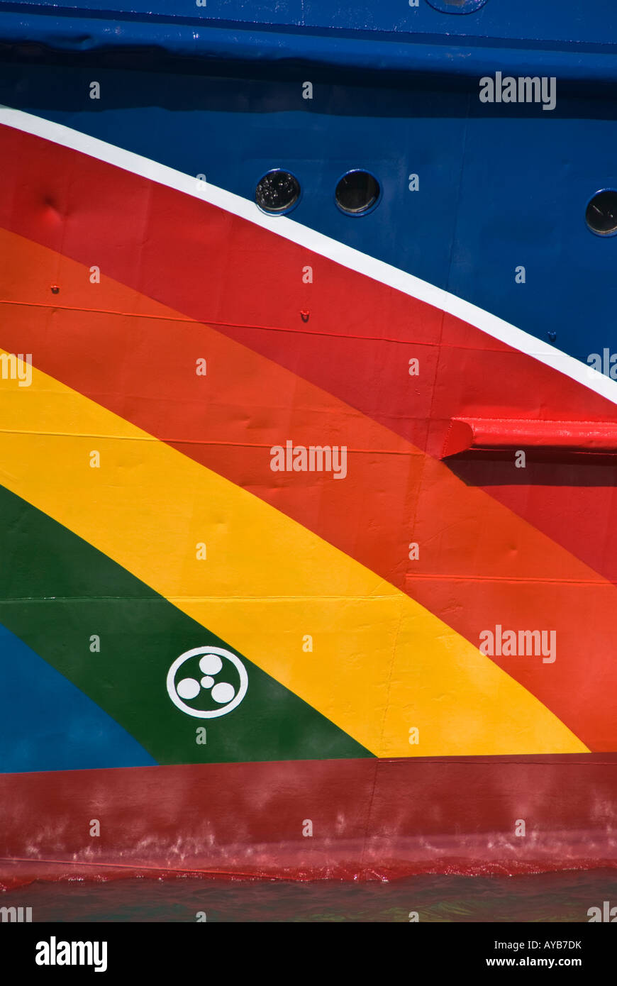 The rainbow logo on the side of a Greenpeace ship freshly painted after being in dry dock. Also shown is a bow thruster symbol. Stock Photo