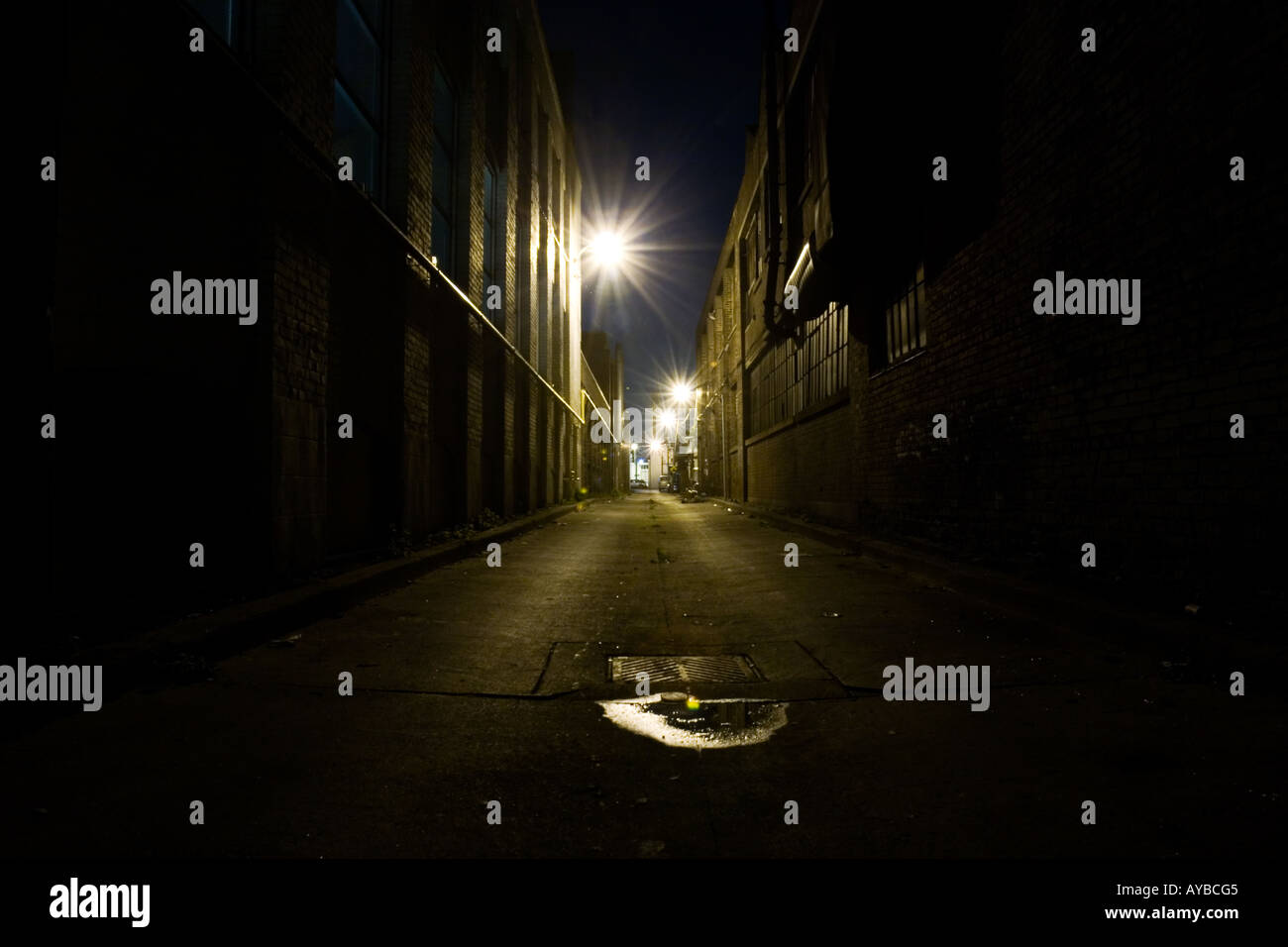 A Dark Brick Alley At Night With Street Light In Background Stock Photo Alamy