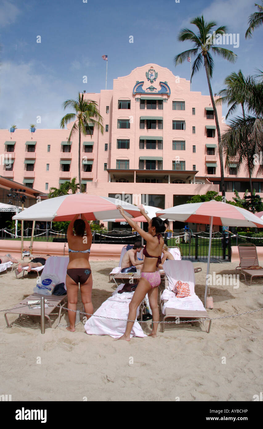 Sunbathers on Waikiki Beach,outside the legendary Royal Hawaiian Hotel also known as the Pink Palace of the Pacific Stock Photo