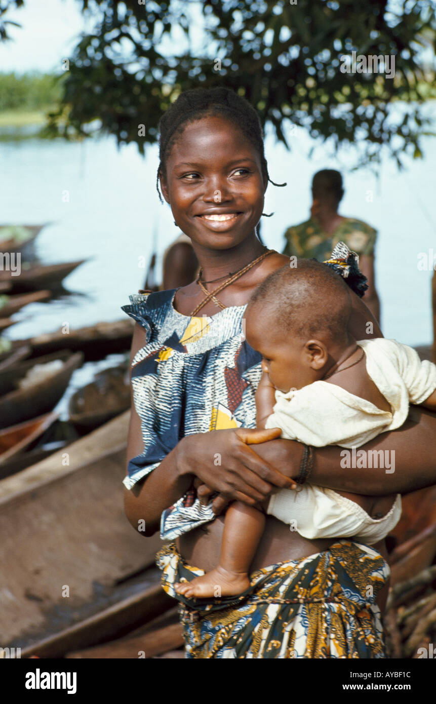 Portrait of smiling woman carrying baby along Ngiri River. Democratic Republic of the Congo ex Zaire Africa Stock Photo