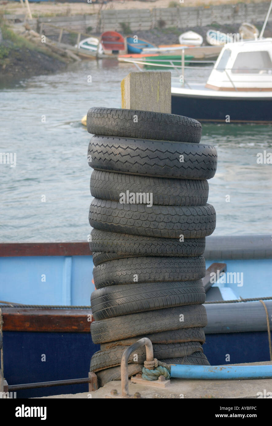 Used car tyres used as fenders to protect boats on the quayside in the