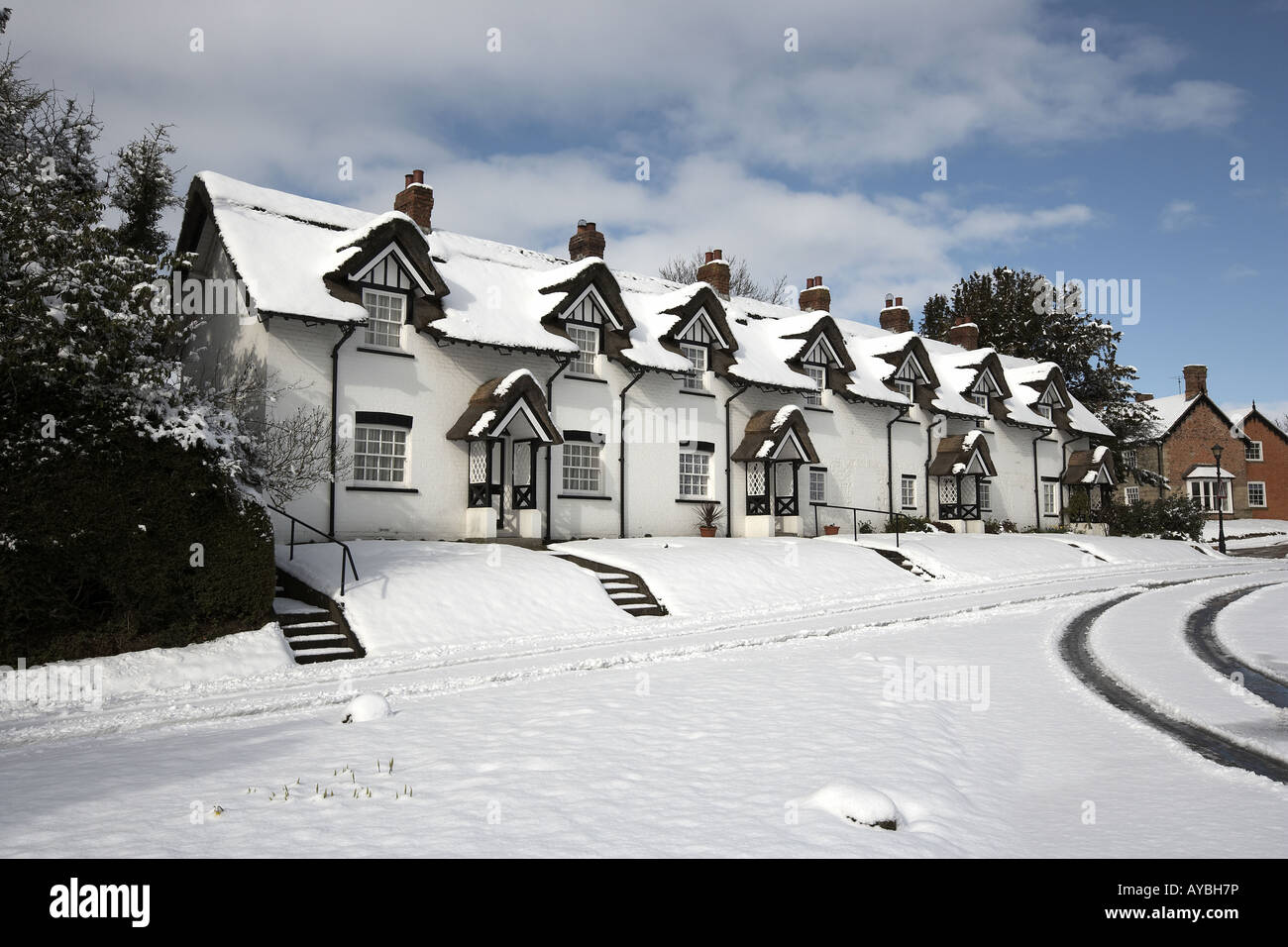The thatched cottages on the green covered in snow Warter East Yorkshire England UK Stock Photo