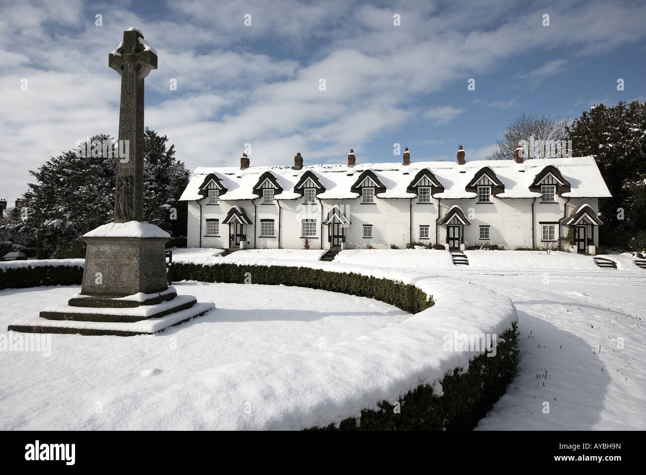 The thatched cottages and war memorial on the green covered in snow Warter East Yorkshire England UK Stock Photo