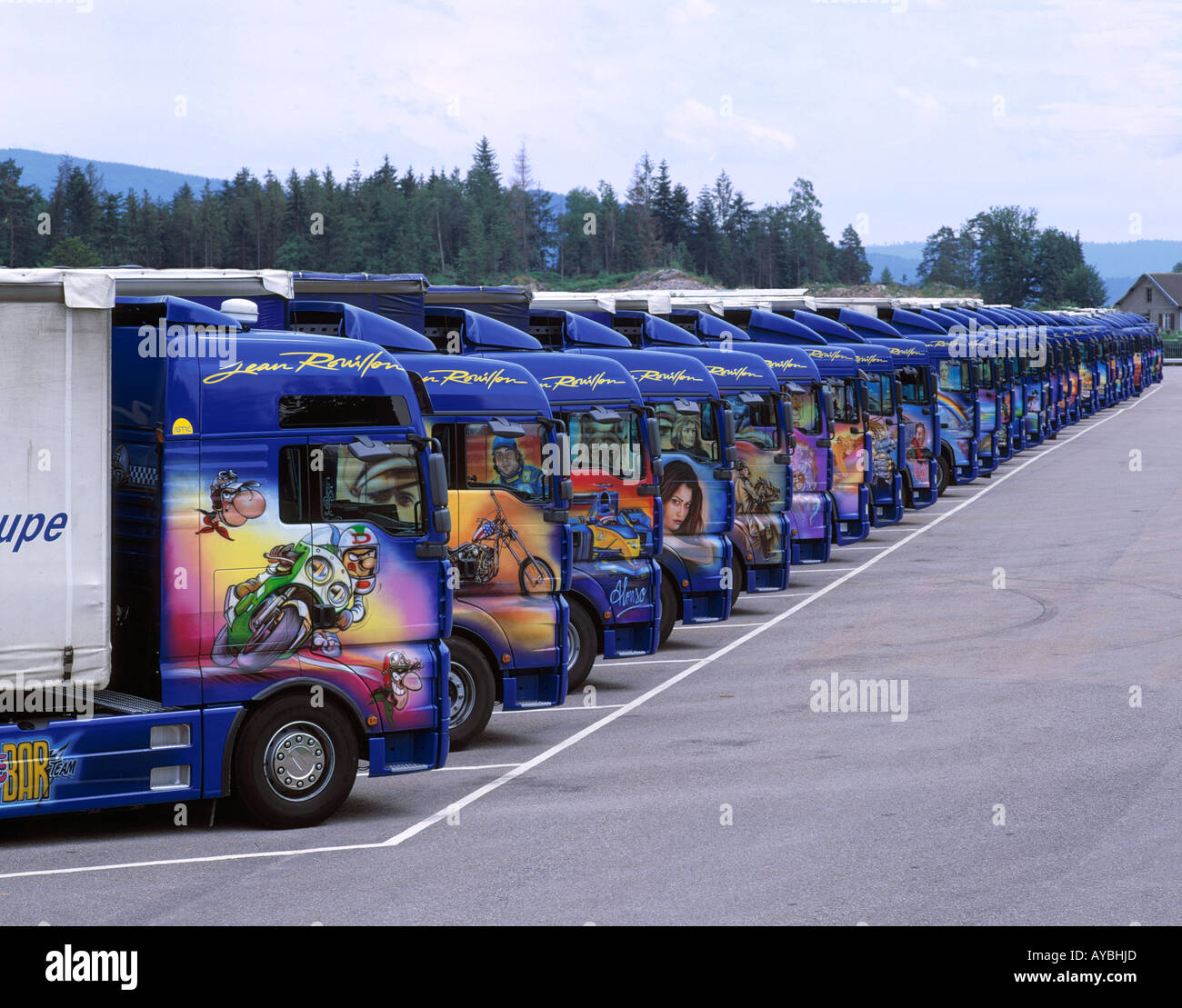 TRANSPORT  DECORATED TRUCKS LINE OF 32 PARKED AT JEAN ROUILLON TRANSPORT Stock Photo