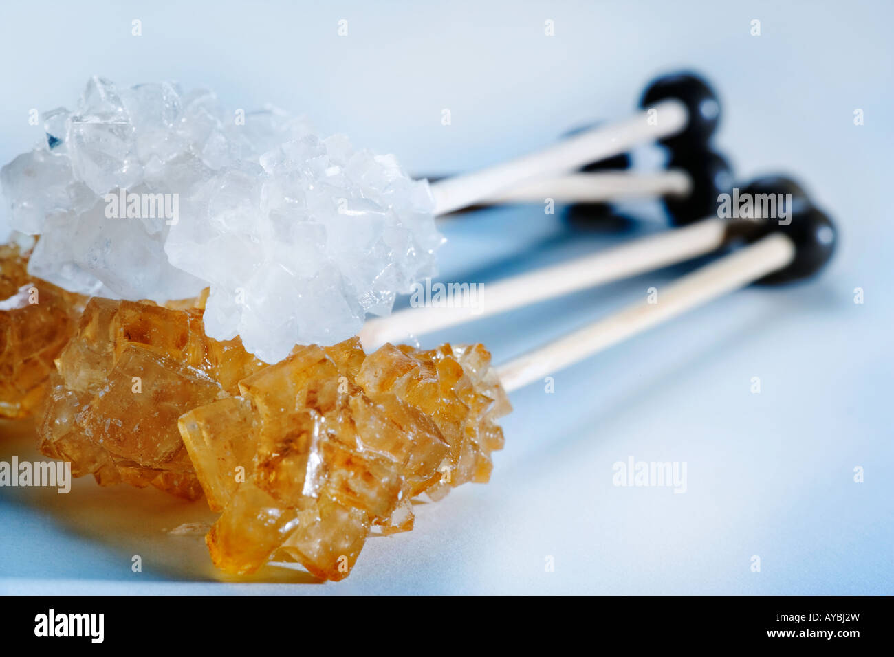 White and brown sugar sticks shot against a white background Stock Photo