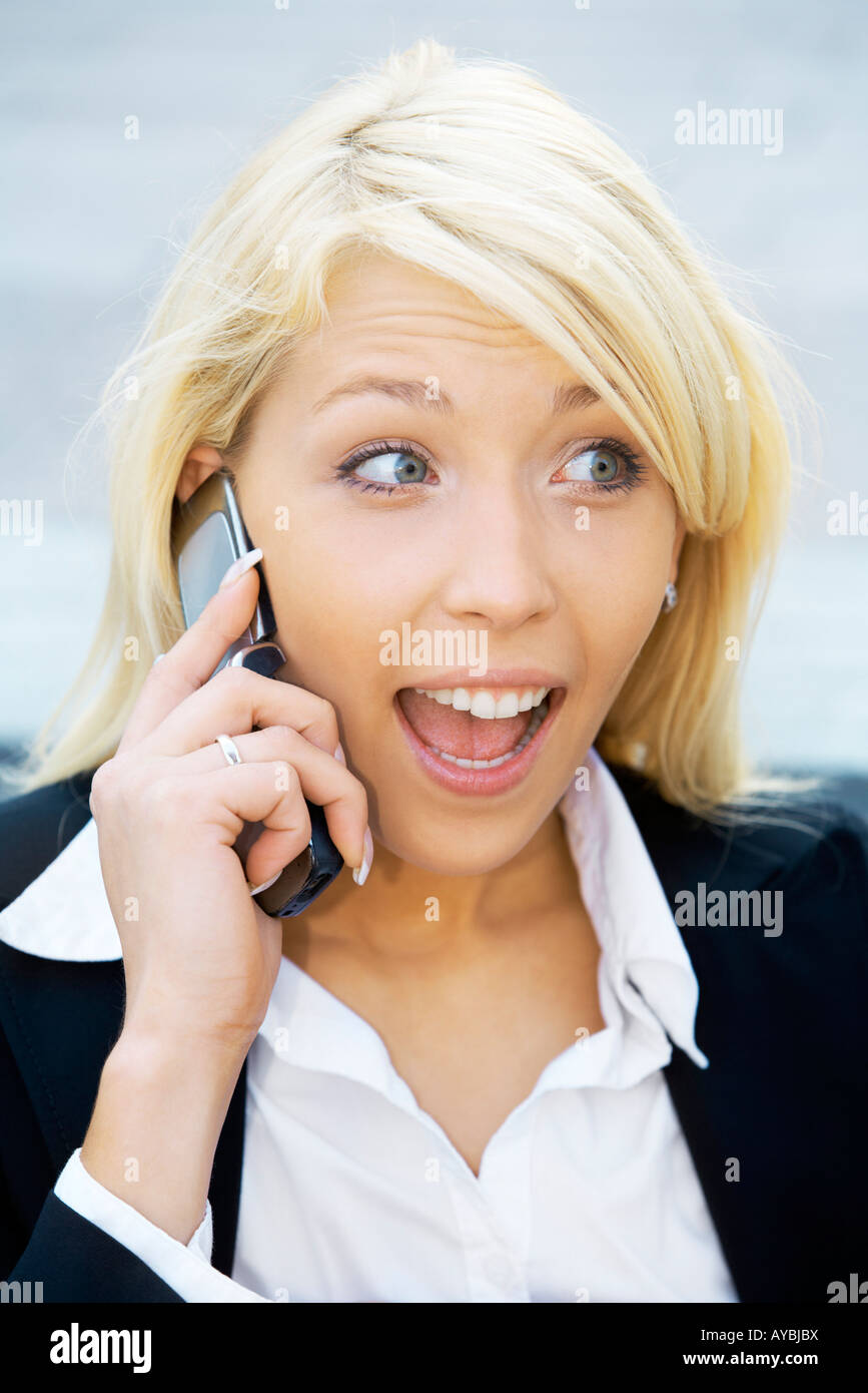 Young using cell phone with suprised expression Stock Photo
