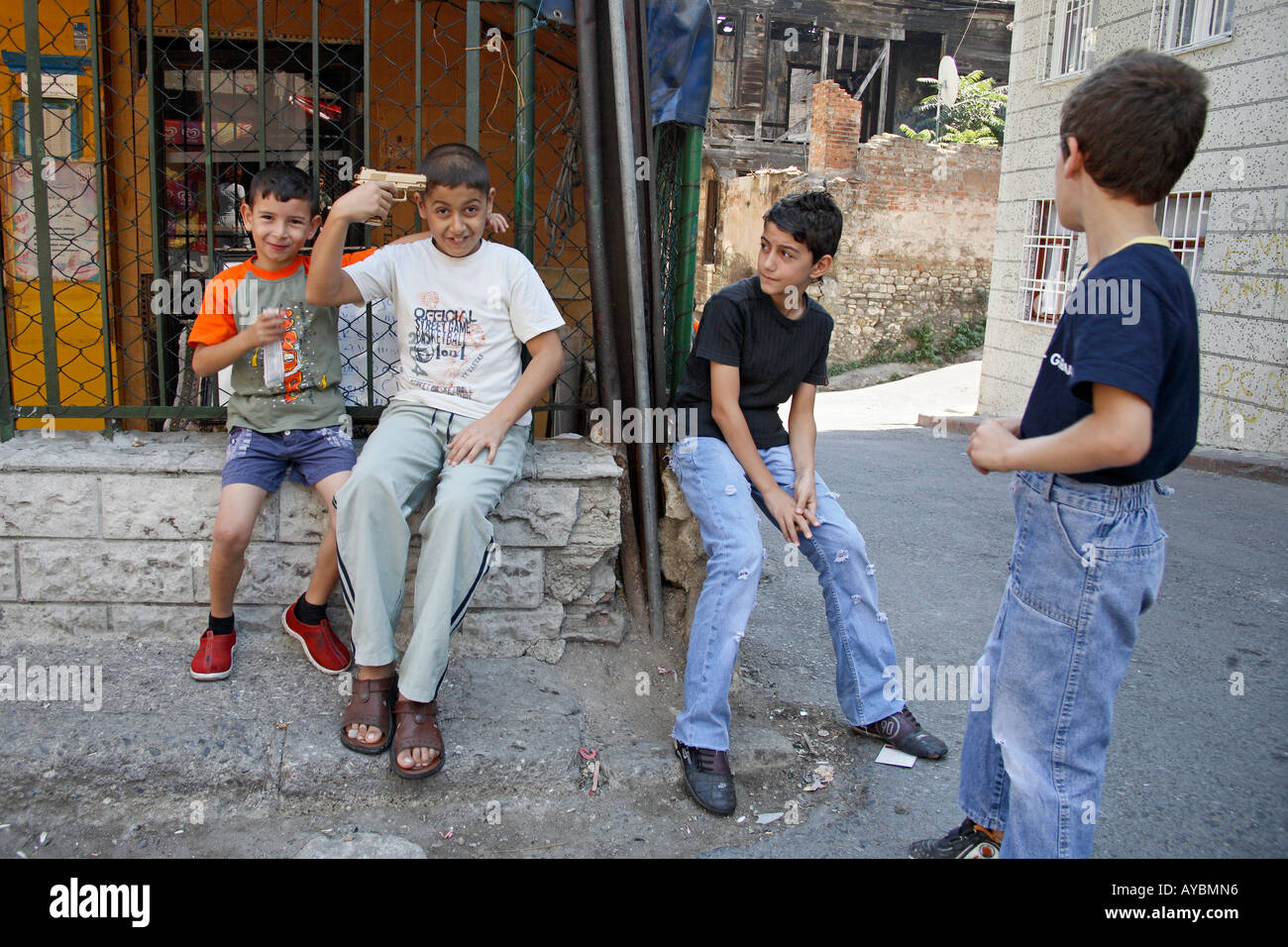 Boy pointing gold toy gun at his own head. Zeyrek, Istanbul, Turkey Stock Photo