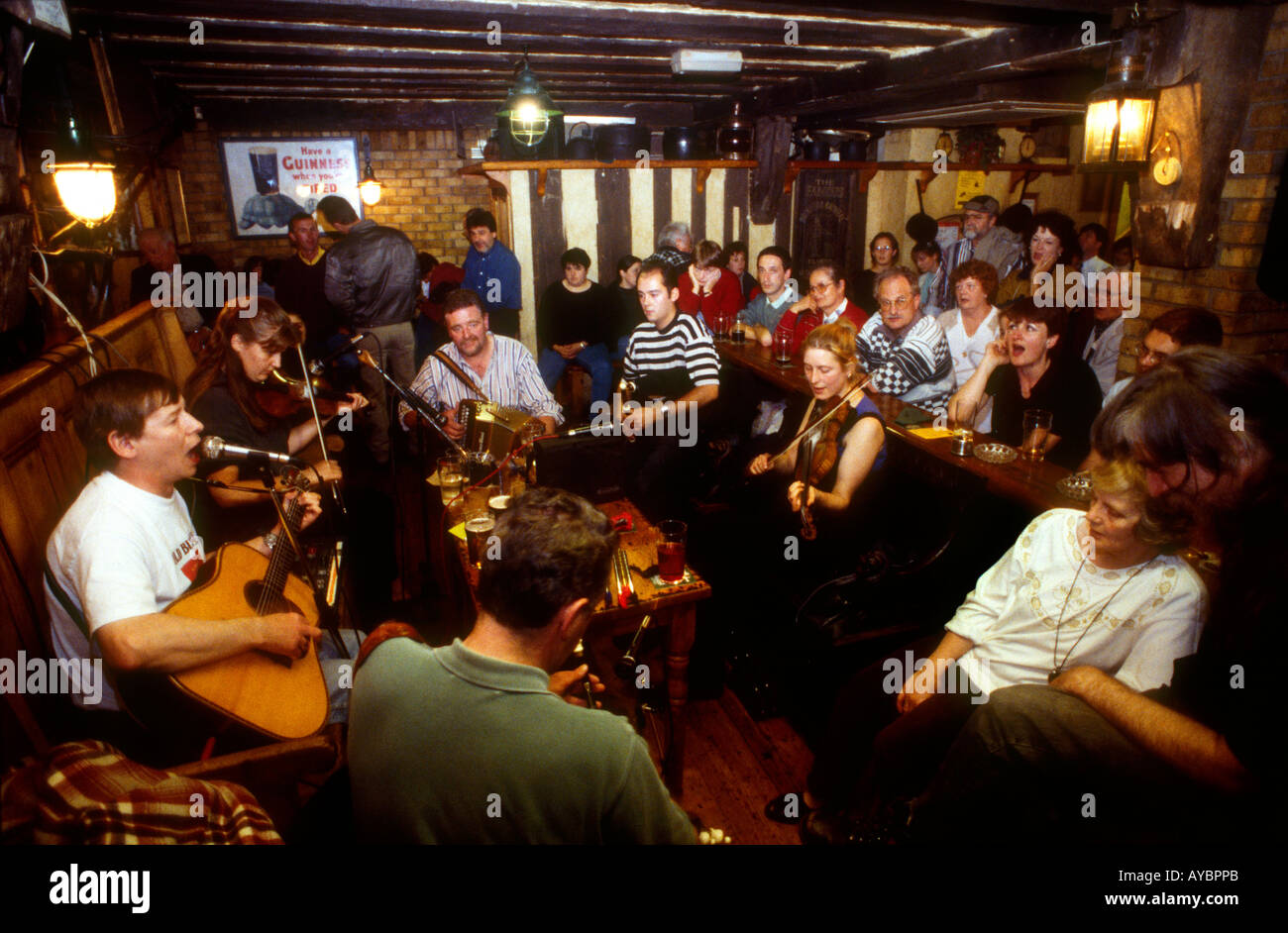 Irish pub with traditional Irish musicians surrounded by pub goers Temple Bar Dublin Ireland Stock Photo