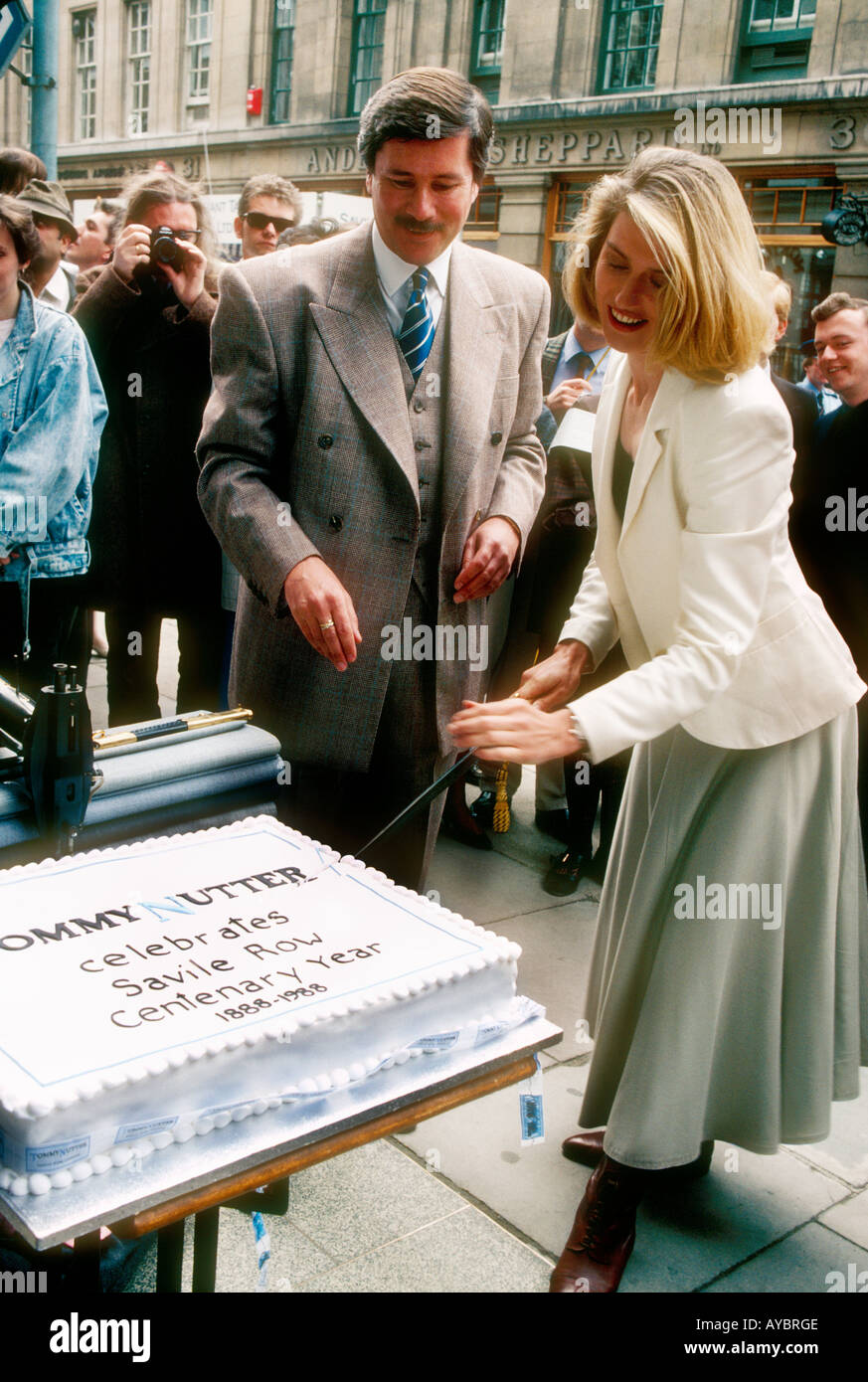 Selina Scott with Bespoke Tailor Tommy Nutter cutting cake with sword during the 1988  Celebrations of the Savile Row,London. Stock Photo