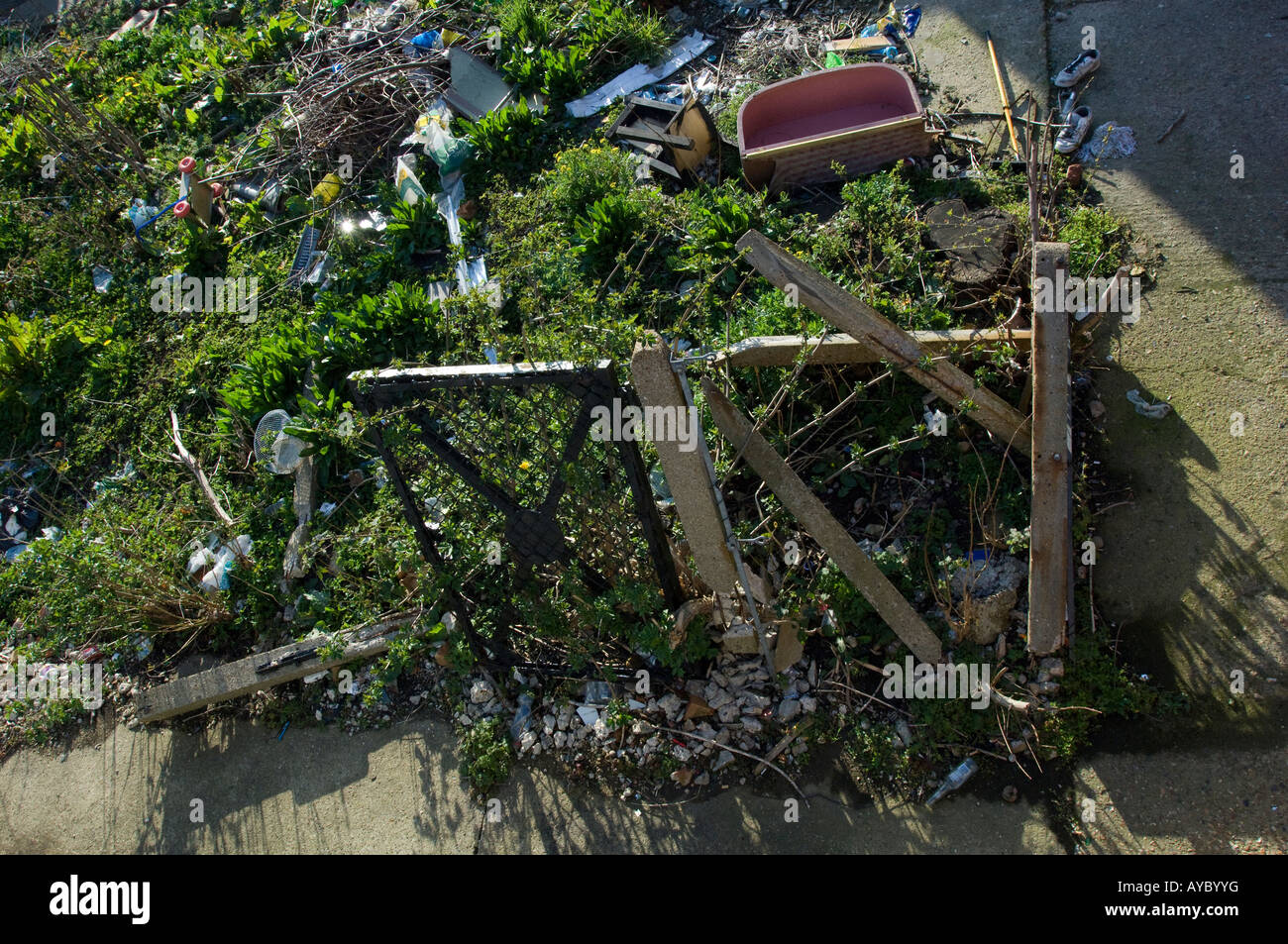 Waste ground used for fly tipping. Rubbish dumped on a patch of unused land. Stock Photo