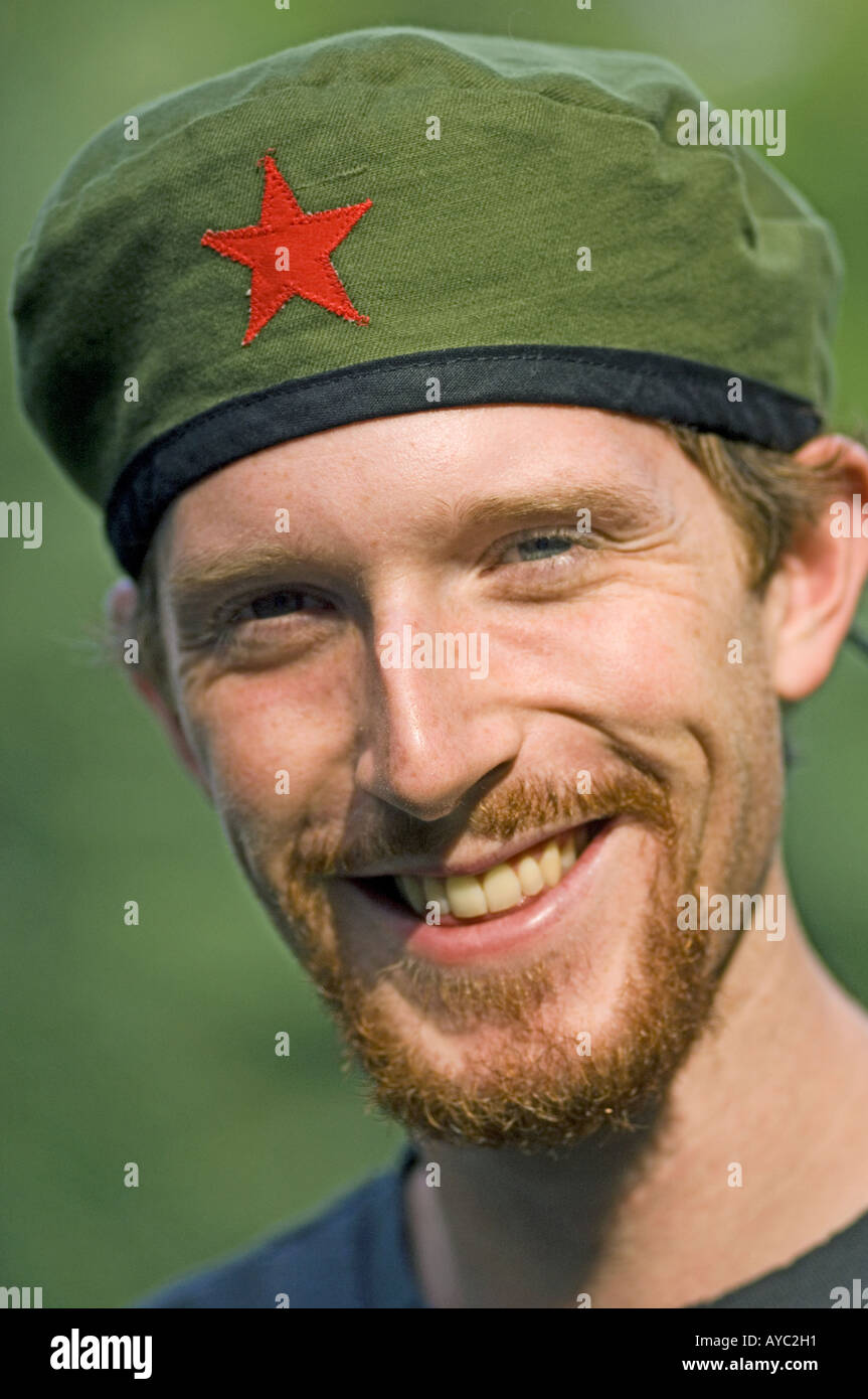 Smiling red haired young man with goatee wearing Cuban beret. Stock Photo