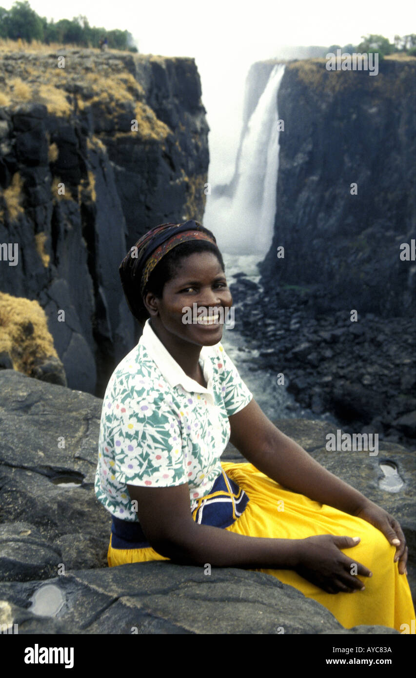 A handsome black African woman in modern dress poses for her photograph at Victoria Falls Zimbabwe Africa Stock Photo