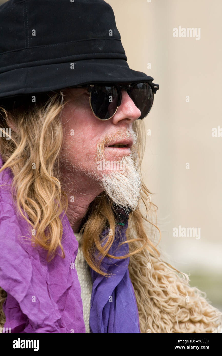 A man with long hair,black hat and 