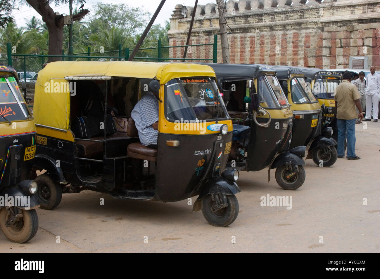 Taxi rank line of auto rickshaws and drivers outside the temple Mysore Stock Photo