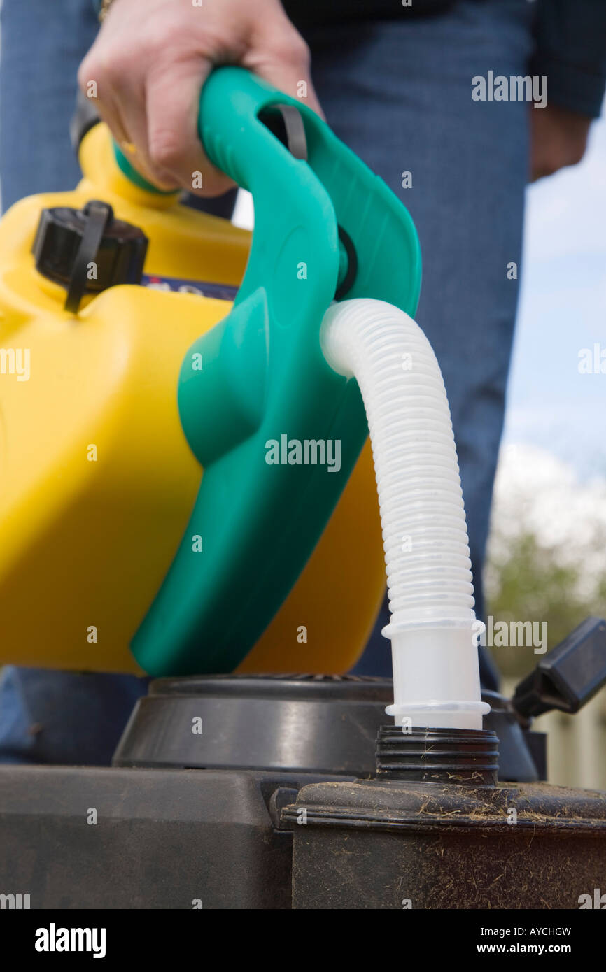 Person filling a tank using NuCan unleaded petrol can. England, UK, Britain Stock Photo