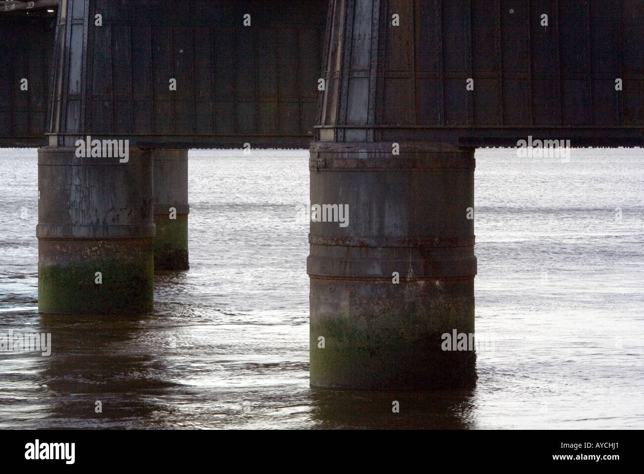 Silhouette of two support legs on the railway bridge across the River Tay at sunset in Dundee Scotland,UK Stock Photo