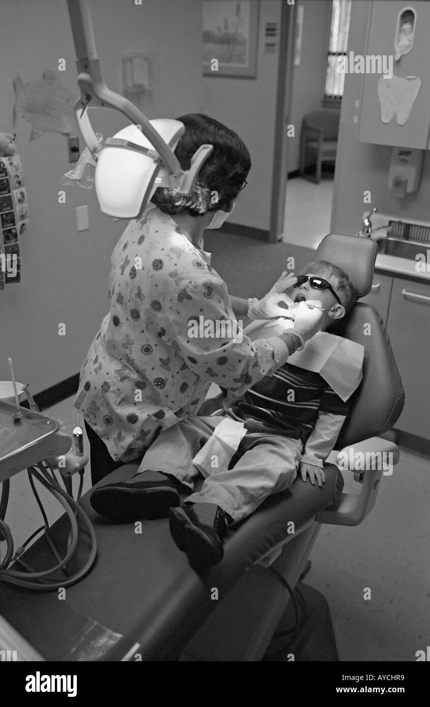 Small boy getting teeth cleaned in a dentist office Stock Photo