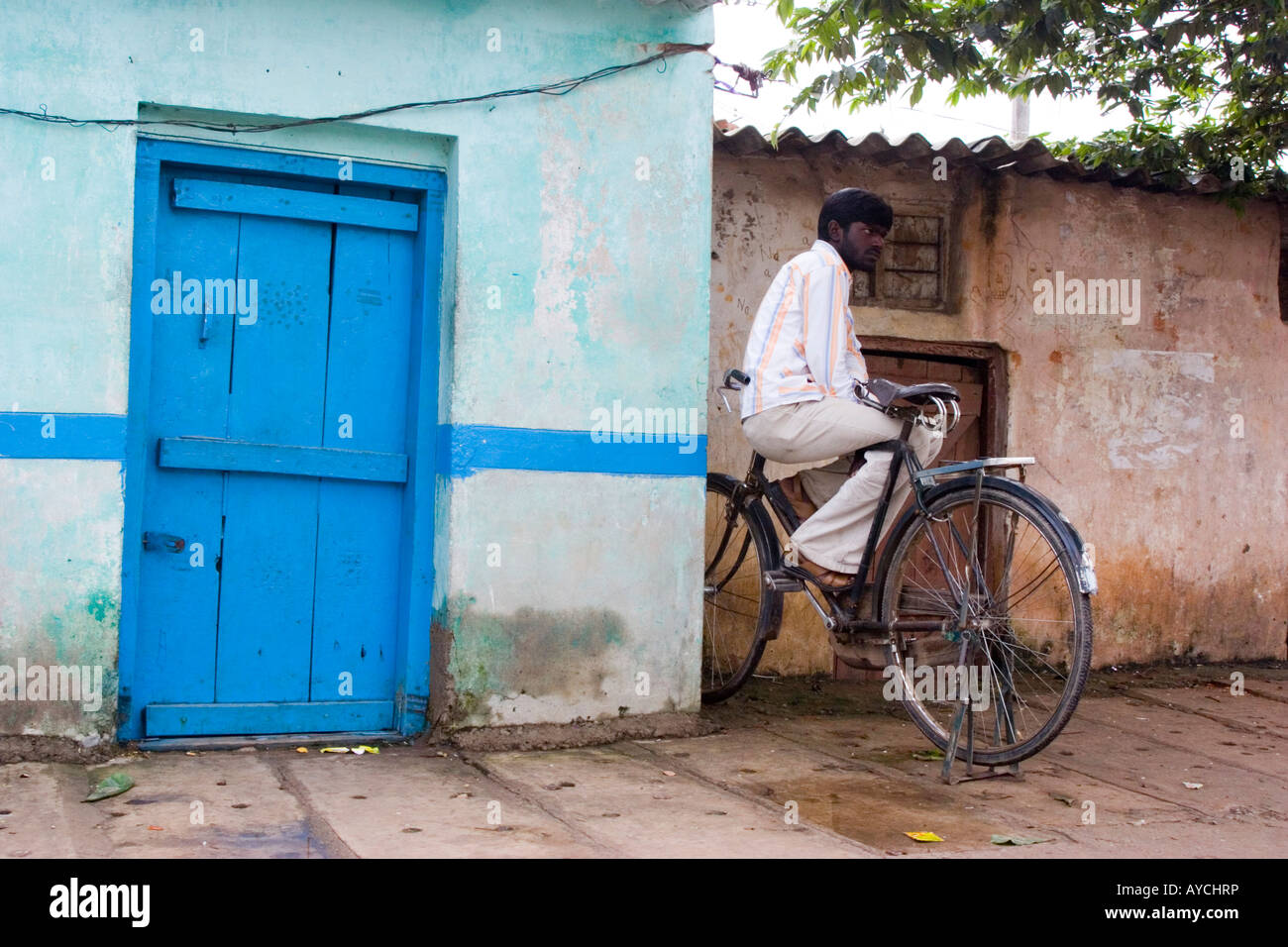 Man sitting alone on a bicycle in the street Banaglore India Stock Photo